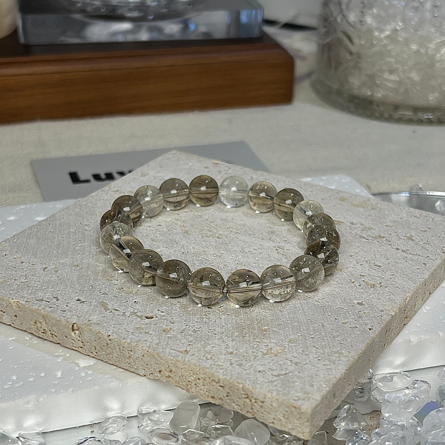 LuvEcho Jewelry's Grounded Wisdom Bracelet showcases 8mm Smoky Azeztulite beads, promoting clarity and stability in your life.