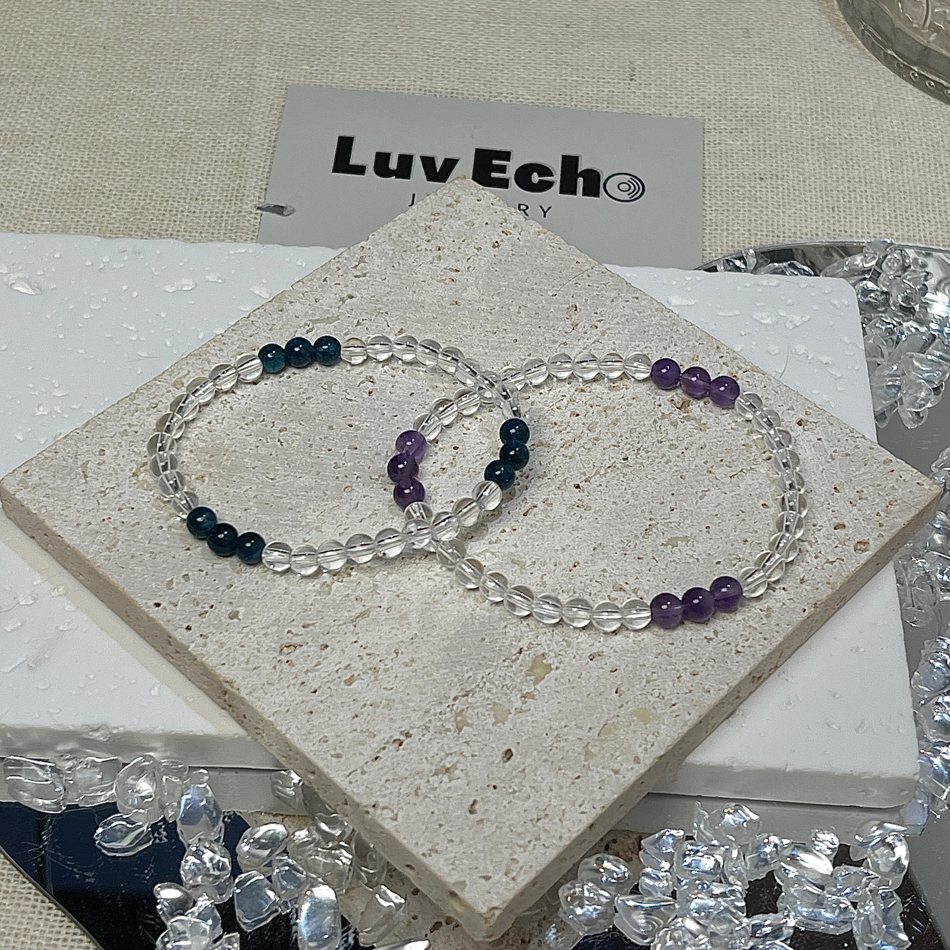 LuvEcho Jewelry set includes the Harmonic Clarity Bracelet and Amethyst Serenity Bracelet, with alternating Crystal Quartz clusters and Amethyst or Blue Apatite for a complete balance of focus and emotional serenity.