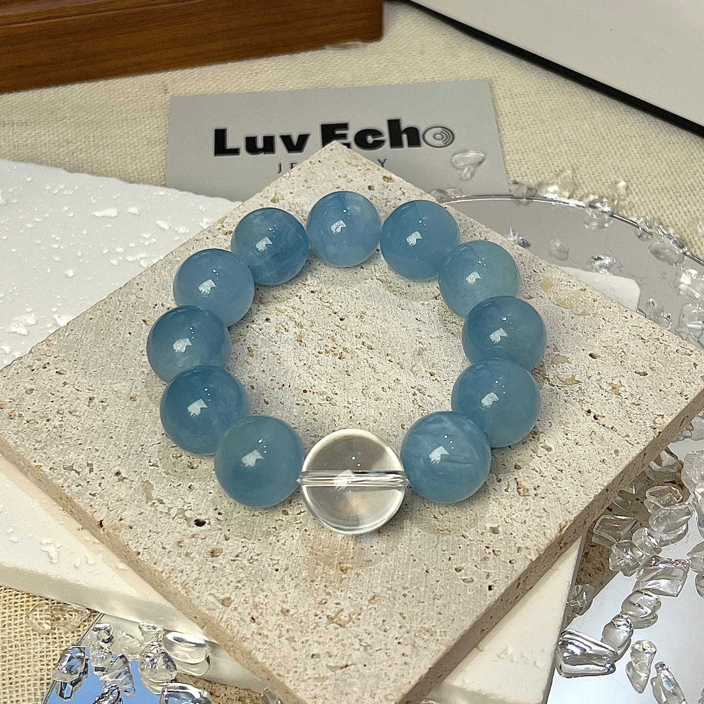 Aquamarine relaxation and self-expression bracelet with 15mm beads and a Crystal Quartz centerpiece.