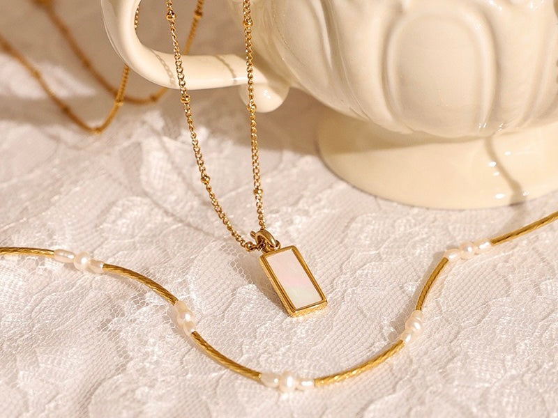 Close-up of the Elle Layered Pearl Shell Necklace details, highlighting exquisite pearls and delicate shells.