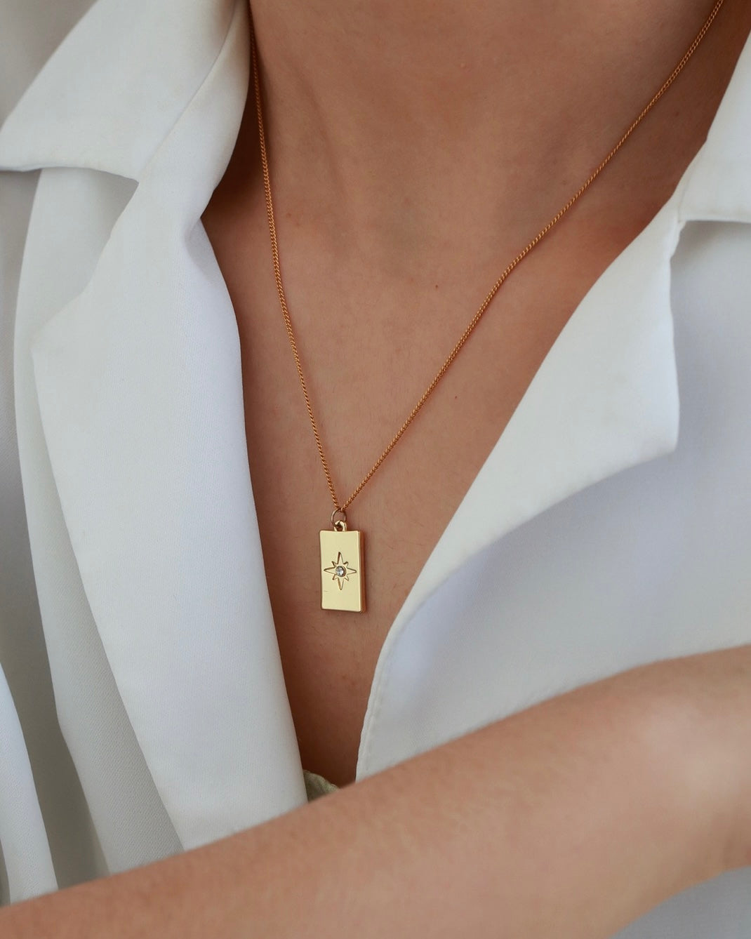 Wear the Iris Octagonal Star Square Pendant Necklace from LuvEcho Jewelry for a touch of minimalist elegance.