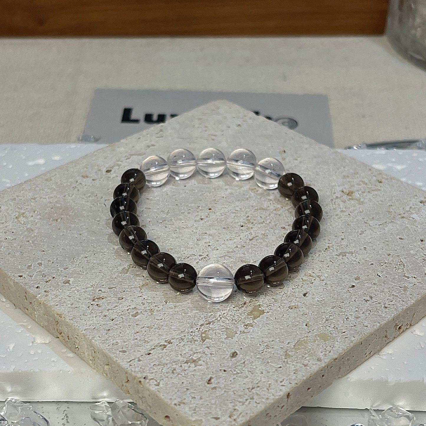 Balanced Aura Bracelet from LuvEcho Jewelry featuring five 8mm Crystal Quartz beads with Smoky Quartz for a design that balances emotional strength and mental focus.