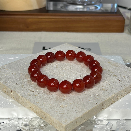 Radiant Energy Bracelet by LuvEcho Jewelry featuring 10mm Light Red Agate beads designed for vitality and emotional stability.
