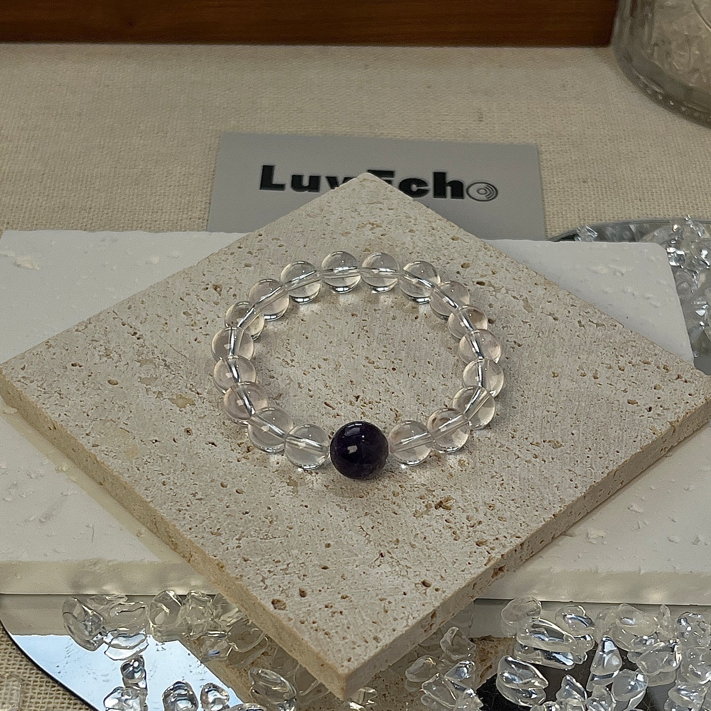 Crystal Clarity Bracelet featuring 8mm Crystal beads and a 10mm Amethyst centerpiece for emotional healing.