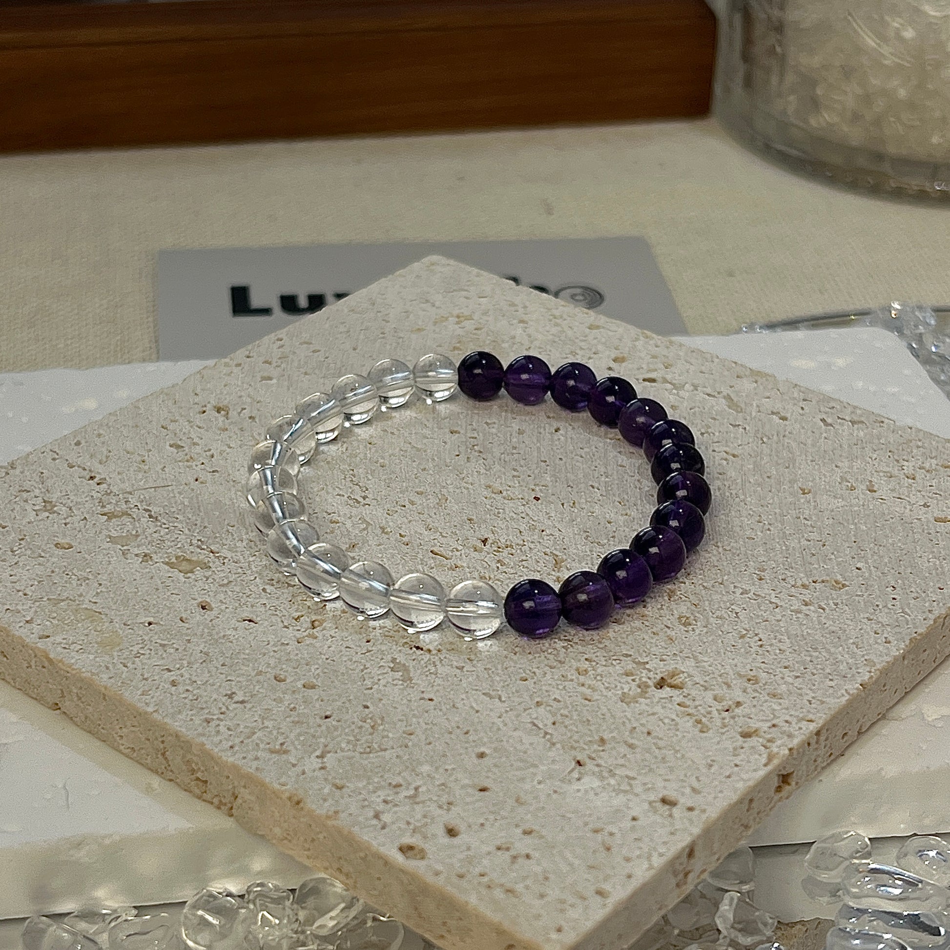 Balanced Energy Bracelet featuring 6mm Amethyst and Crystal beads, promoting emotional stability and clarity.