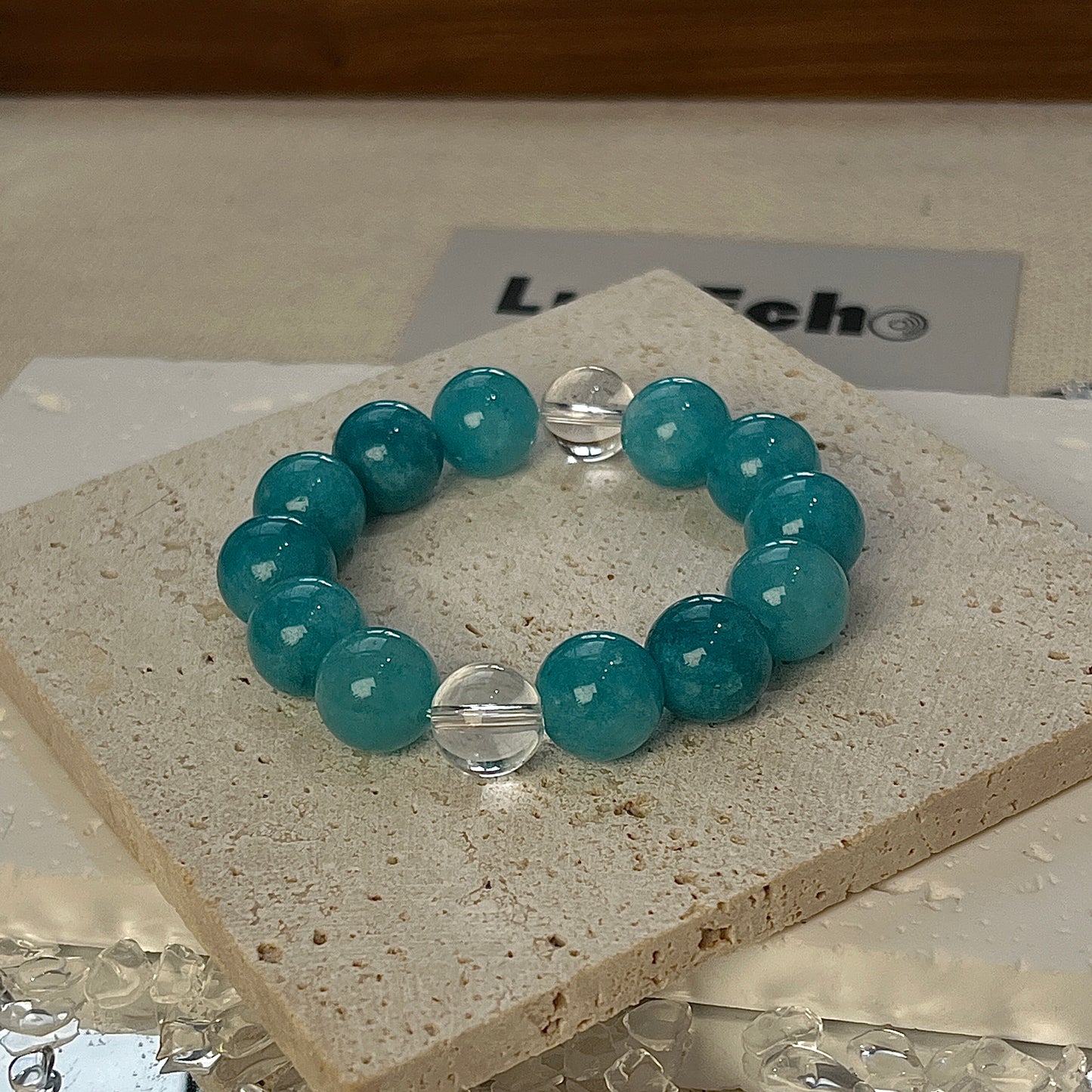 Tranquil Balance Bracelet featuring 12mm Amazonite beads and two Crystal Quartz beads on each side for emotional harmony.