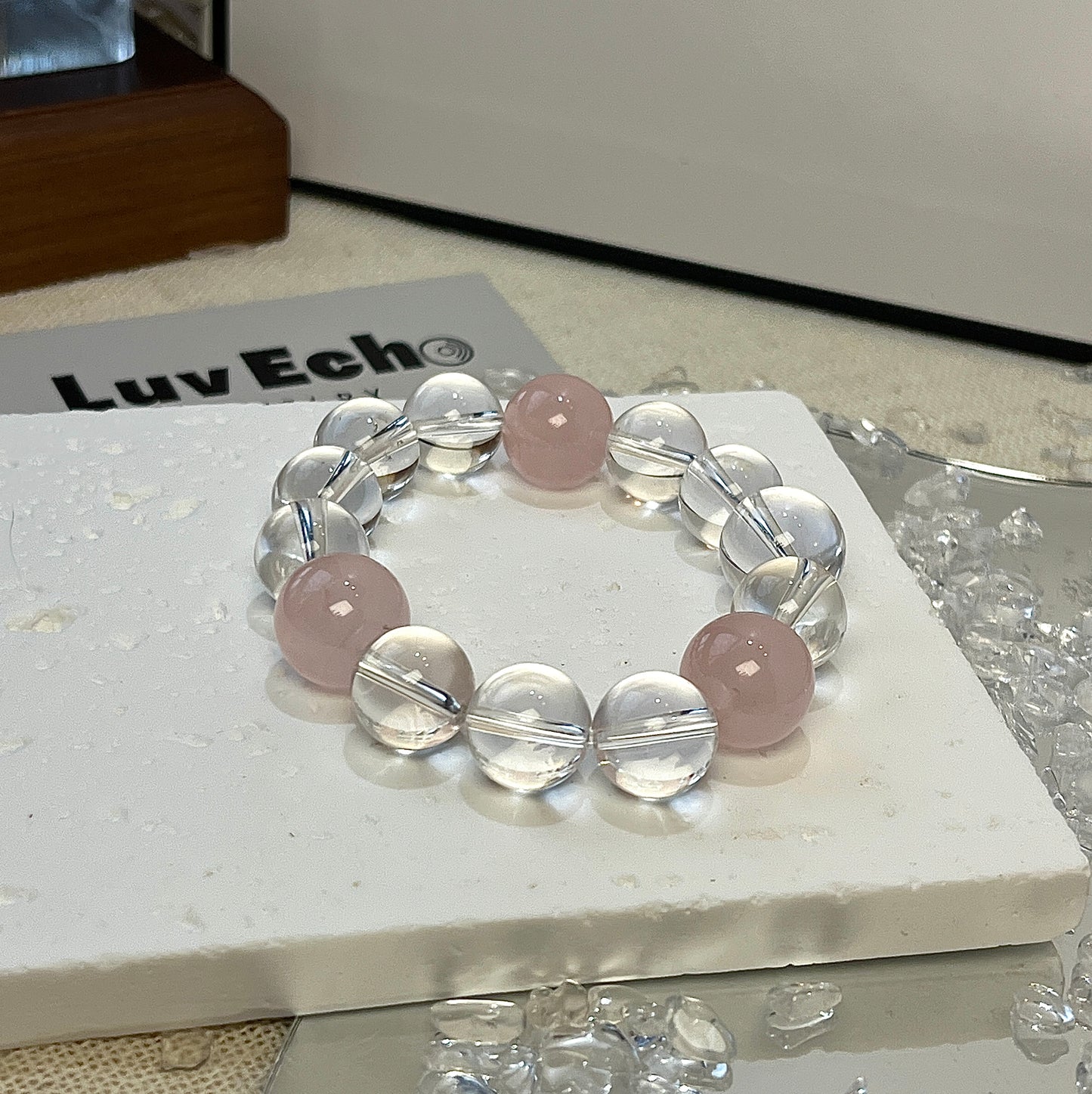 A bracelet of 13mm Rose Quartz and Crystal Quartz beads designed to support emotional healing, self-love, and inner peace with amplified positive energy.